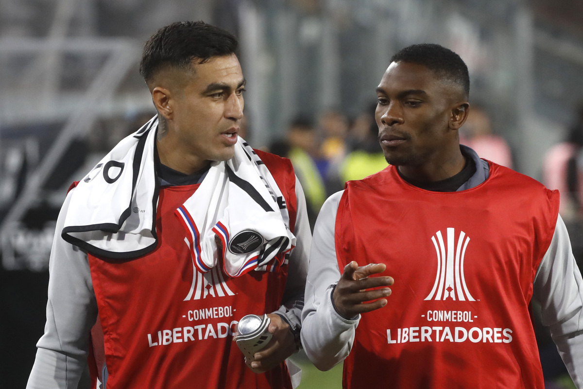 Darío Lezcano y Fabián Castillo conversando camino a la banca de suplentes de Colo-Colo durante la temporada 2023.