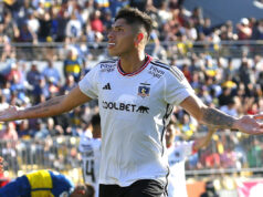 Carlos Palacios sonriendo con los brazos abiertos.