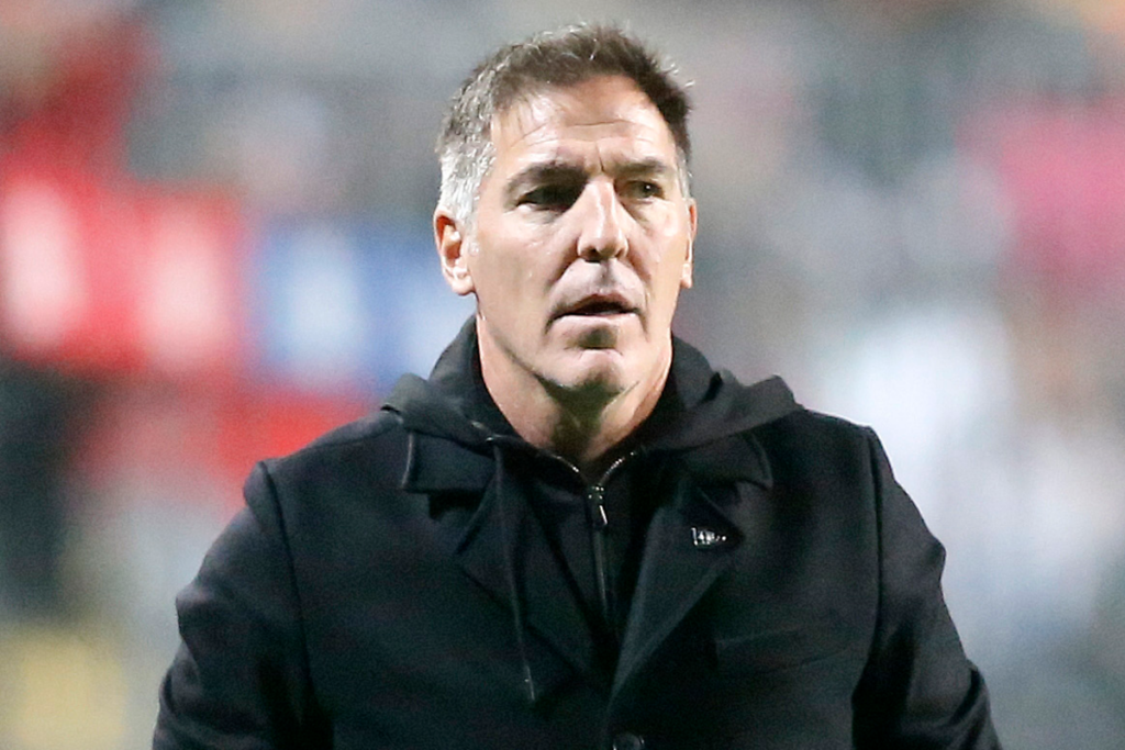 Eduardo Berizzo con cara de impacto y la boca semiabierta.