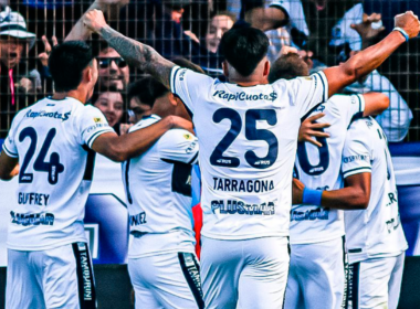 Futbolistas de Gimnasia y Esgrima de la Plata se abrazan y celebran un gol durante la temporada 2023.