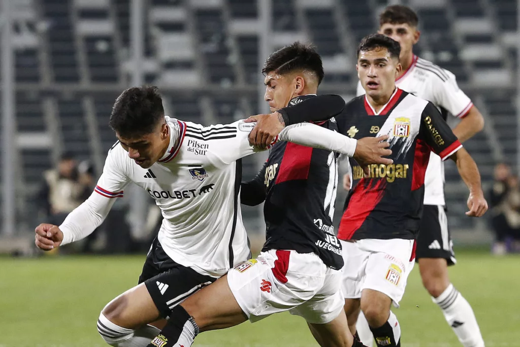 Damián Pizarro disputando una pelota con un rival en el duelo entre Colo-Colo y Curicó Unido.