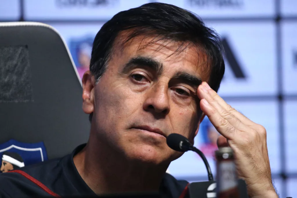 Gustavo Quinteros con la mano en la cabeza en plena conferencia de prensa.