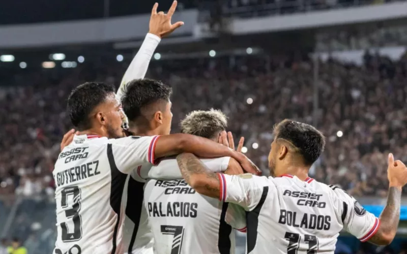 Tres futbolistas de Colo-Colo festejando un gol