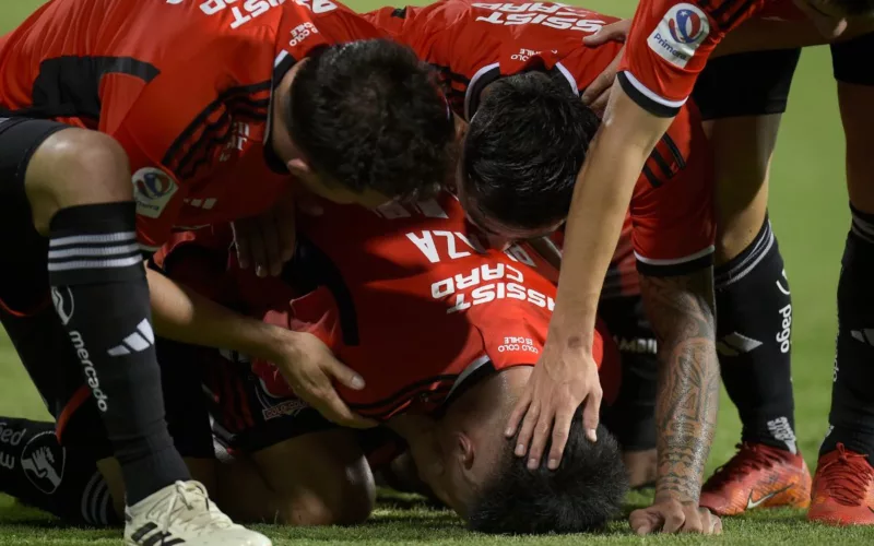 Futbolistas de Colo-Colo arrodillados en la cancha