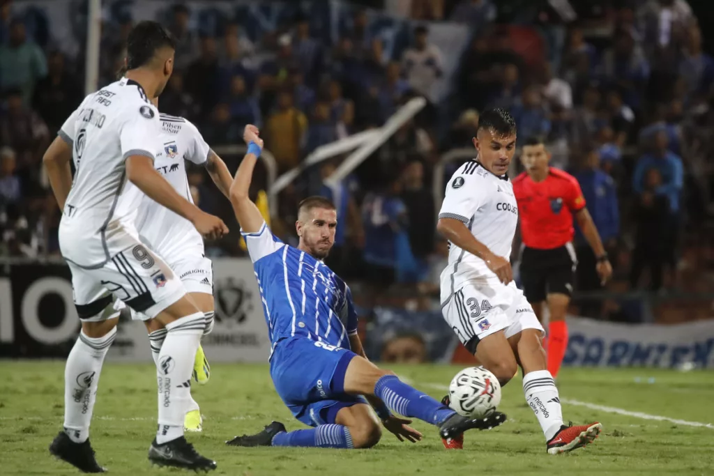 Jugador de Godoy Cruz peleando un balón con jugadores de Colo-Colo.