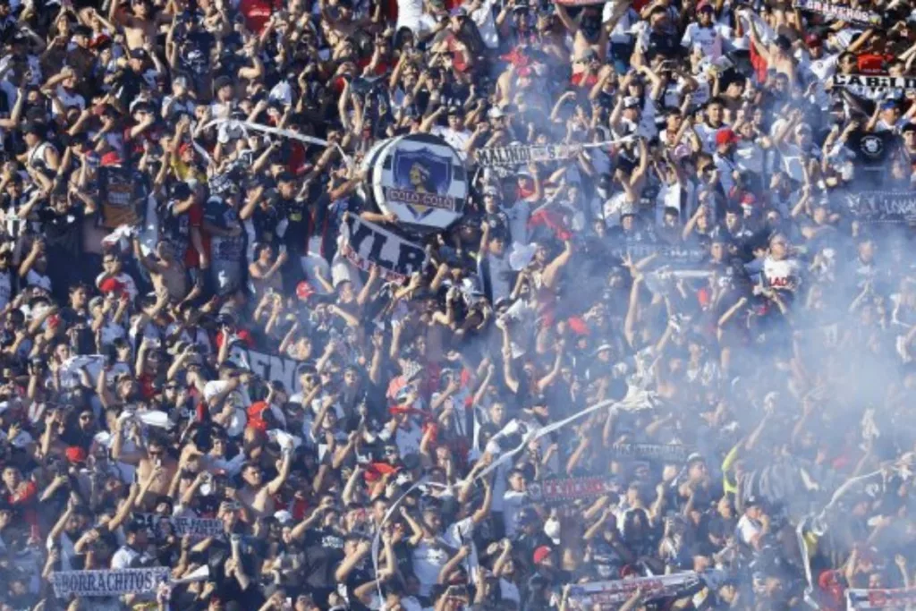 Hinchas de Colo-Colo alentando en el estadio.