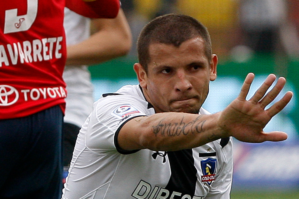 Emiliano Vecchio levanta su mano en señal de disculpas en pleno partido defendiendo la camiseta de Colo-Colo ante Unión Española.