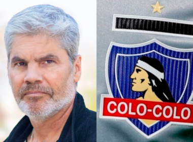 Primer plano al rostro serio del periodista Juan Cristóbal Guarello, mientras que a mano derecha se puede ver el escudo de Colo-Colo.