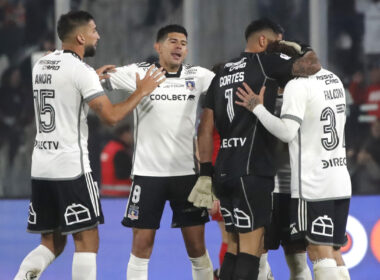 Jugadores de Colo-Colo abrazándose en la cancha.