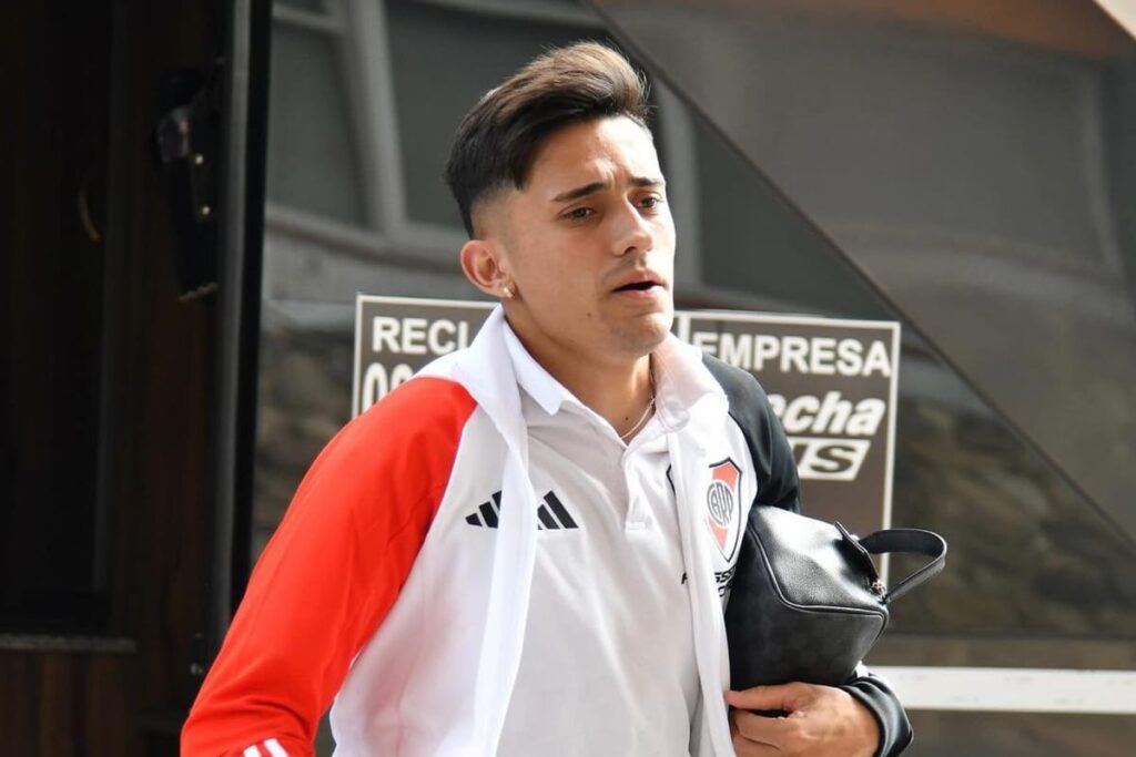 Primer plano a Pablo Solari bajando de un bus con indumentaria de River Plate.