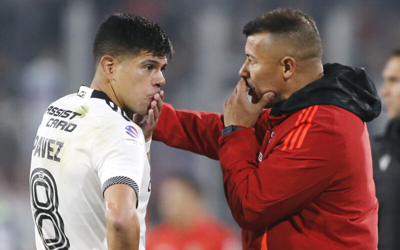 El técnico Jorge Almirón entregando instrucciones al capitán de Colo-Colo, Esteban Pavez