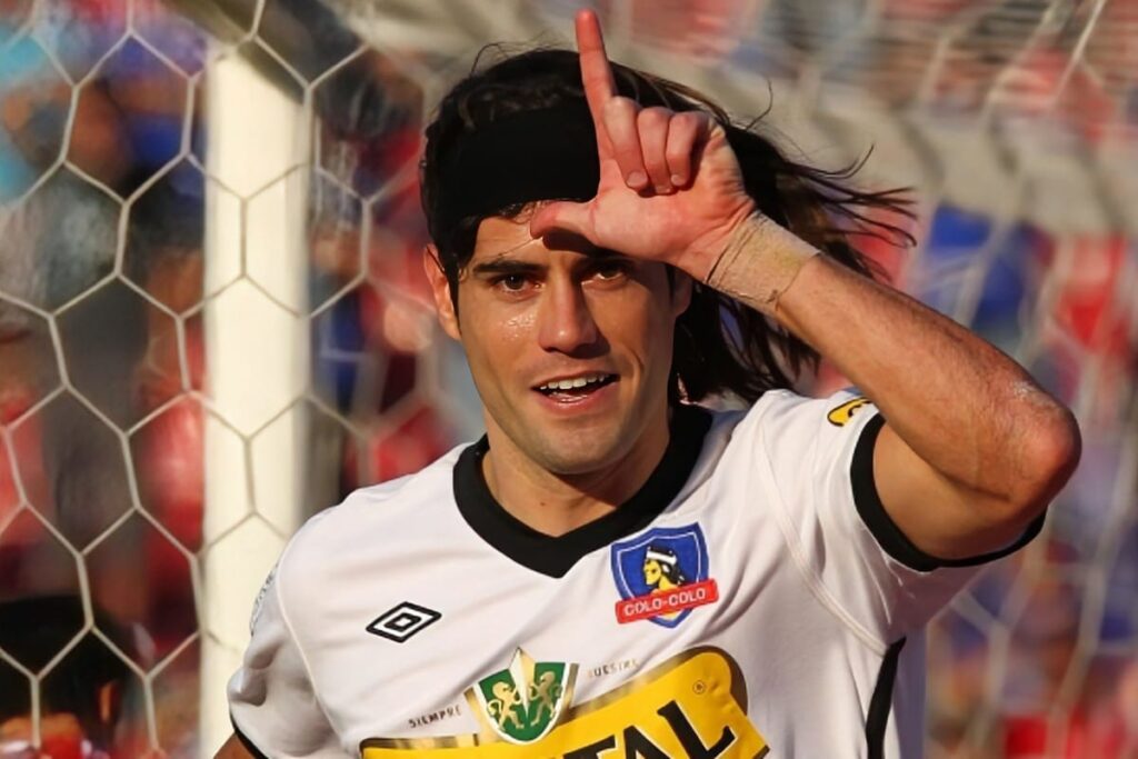 Ezequiel Miralles celebrando un gol en un Superclásico haciendo una letra L con sus dedos a la altura de la frente.