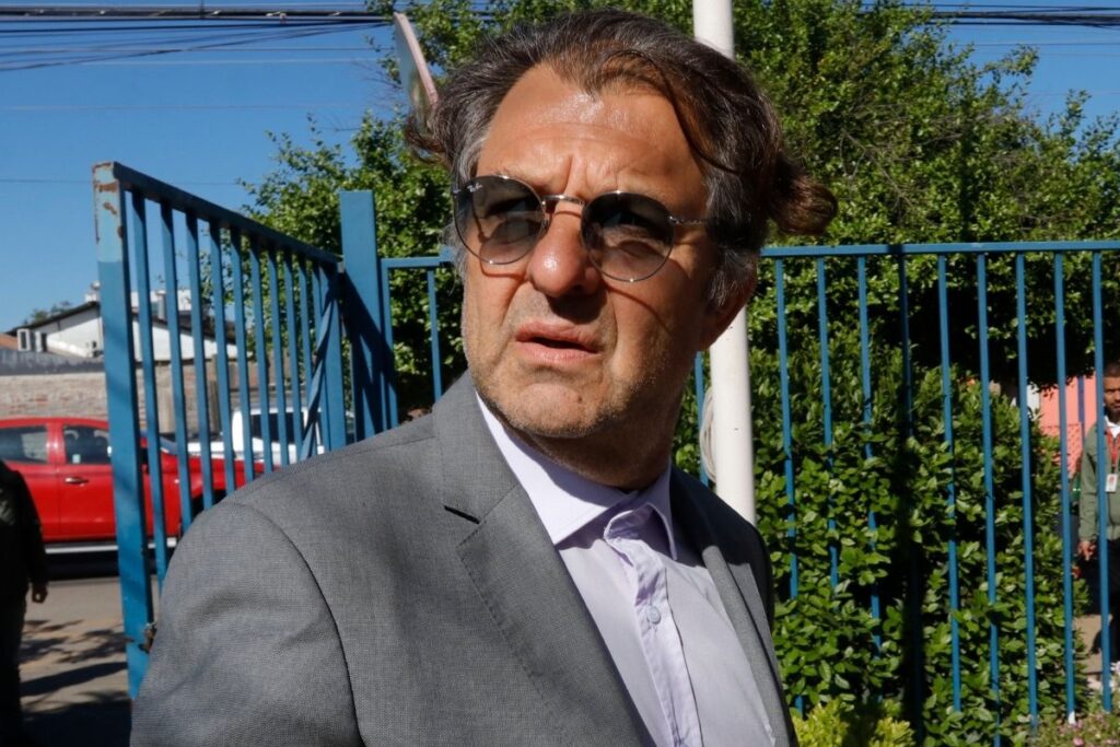 Aníbal Mosa con terno y lentes de sol.