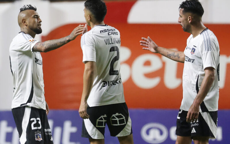 Jugadores de Colo-Colo saludándose durante un partido.